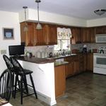 Kitchen remodel including new counter tops, tile back splash, remove wall between kitchen and dining area, new island and pendant lighting
